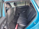 a blue car with black seats in the back of it
