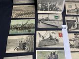 some old postcards of ships and boats are on a table