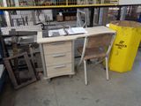 an image of a desk and chair in a warehouse