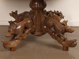 a wooden table with carved animals on top of it