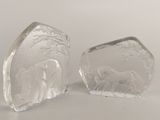 pair of clear glass bookends with elephants and trees on them