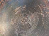 an image of a metal bowl with a hole in it