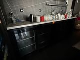 a kitchen with a lot of bottles on the counter