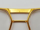 gold rimmed glasses with clear lenses on a white surface