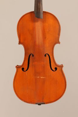an old violin with a bow hanging from the back