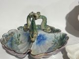 two decorative dishes that are sitting on a table