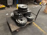 a lot of rims on a cart in a warehouse