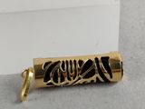 a close up of a gold pen on a white surface