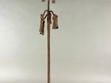 a tall pole with a bunch of bells on top of it