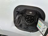 an electric car plugged in to a charging station at a charging station