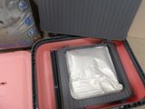 two pieces of luggage sitting on top of a floor next to each other