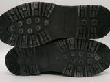 the soles of a pair of black shoes on a white background