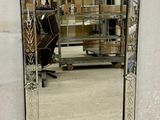 a mirror that is sitting on the floor in front of a wall