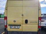 a yellow van that is parked in a parking lot