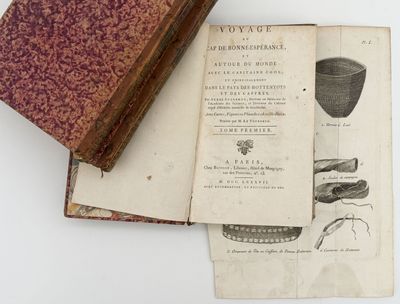 a book opened on top of a book with a picture of a vase on it