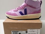 a close up of a pair of purple shoes on a box