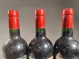 three bottles of wine sitting next to each other on a table