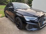 a black audi is parked on the side of the road