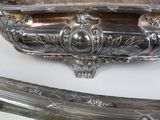 a silver tray on a table with a razor on it