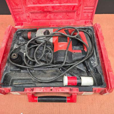 a red tool case with tools in it on a table