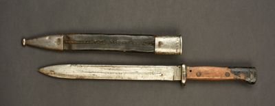 pair of knives on a table with a black background