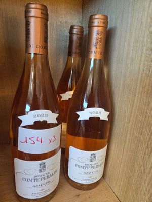 three bottles of wine sitting on a shelf next to each other
