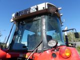 a red tractor that is parked on the side of the road