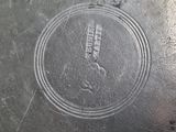 a close up of a metal plate with a logo on it