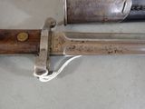 a close up of a knife with a wooden handle on a table