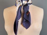 purple silk scarf with white flowers on a mannequin neck