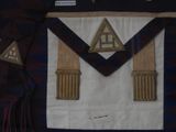 a picture of a masonic apron with a triangle on it