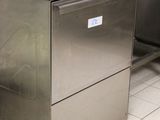 a large stainless steel dishwasher in a commercial kitchen