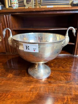 a silver bowl sitting on a wooden table