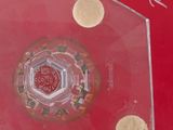 a picture of a glass plate with a red design on it