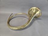 an antique brass trumpet with a brass handle on a white background