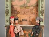 dolls sitting on a bench in front of a picture of a city