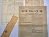 several old papers and a piece of paper on a table