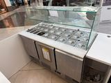 a display case with a lot of food inside of it