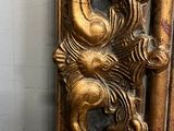 a gold colored mirror with a gold dragon on it