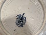 a person holding a plate with a logo on it
