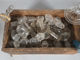 a wooden box filled with glass bottles and wine glasses