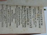 a person holding an old book with writing on it