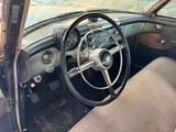 a steering wheel and dashboard of an old car