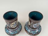 pair of blue and brown vases sitting on top of a white table