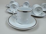 six cups and saucers sitting on a white table
