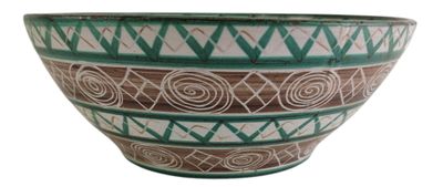 a green and white bowl with a design on it