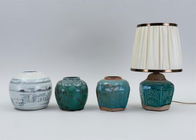 trois vases et une lampe posés sur une table