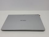 the back of a silver laptop computer sitting on a white surface