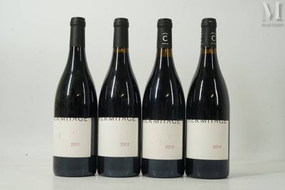 three bottles of wine are lined up on a white surface