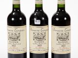 three bottles of wine sitting next to each other on a white surface